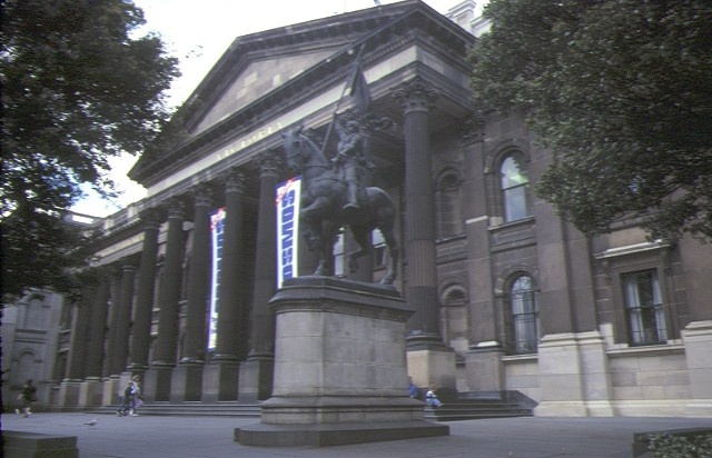 State Library of Victoria and Museums Complex, 1985, showing building facade with the statue of St Joan of Arc in the foreground