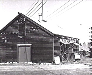 Diggers Rest, November 1945. The exterior of the old 'shack' at Diggers Rest, used by Land Headquarters Signals to house transmitters. This would have been one of the converted farm buildings. (Australian War Memorial)