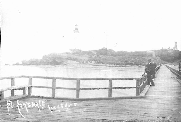 The second lighthouse (1901-02) and the old timber lighthouse from Shortlands Bluff from the Point Lonsdale Pier c.1910.