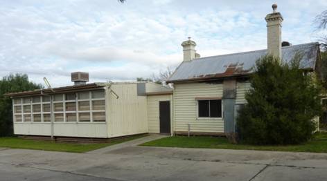 Rear view of the police station and quarters, with the classroom addition at left (east).