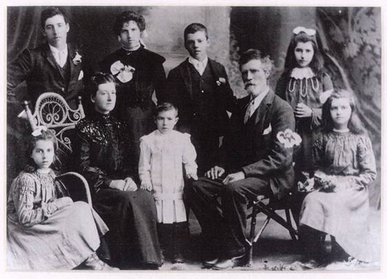 Kelly Family, 1904. Left to right: Susan (Tot), George, Sarah (Mother), Kathleen (Kit), Daniel (Jr.), Joe, Daniel (Father), Grace, Eliza. Photo supplied by Betty Dean, granddaughter of Daniel and Sarah Kelly.
