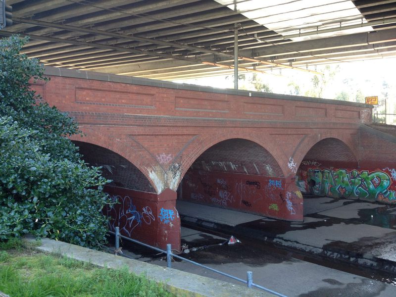 The east side of the bridge showing original 1891 brick arched construction.