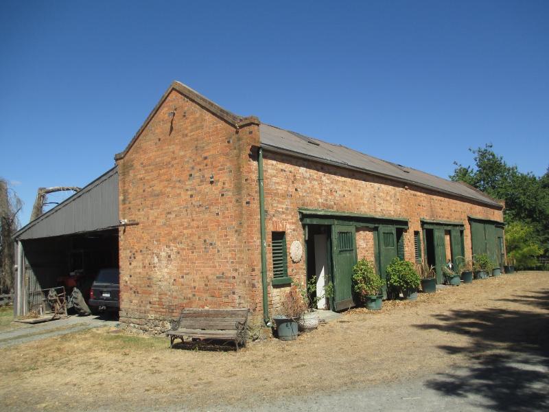 Historic stables building, with lean-to at left.