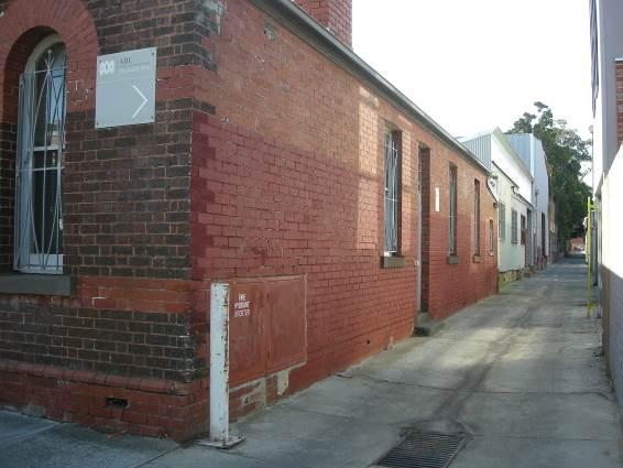 View from Selwyn Street along un-named laneway, showing painted areas of face brickwork on south elevation