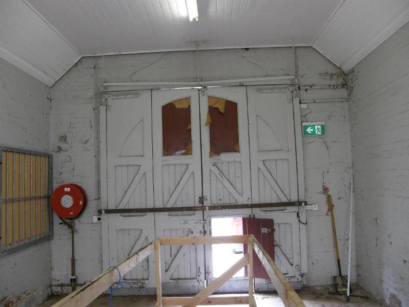 Looking west at the timber and glass doors to the former fire engine room