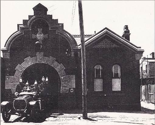 c.1918: Selwyn Street elevation with Hotchkiss Fire Engine and crew. The Station's original roof materials are visible