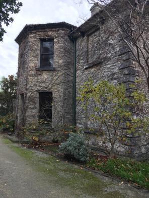 c.1882 polygonal bayed wing on left, abutting 1856-57 fabric containing two blind windows on right.