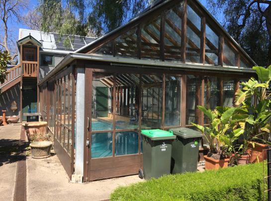 Looking south from northeast corner of 1991 pool-enclosure building, with garage beyond.