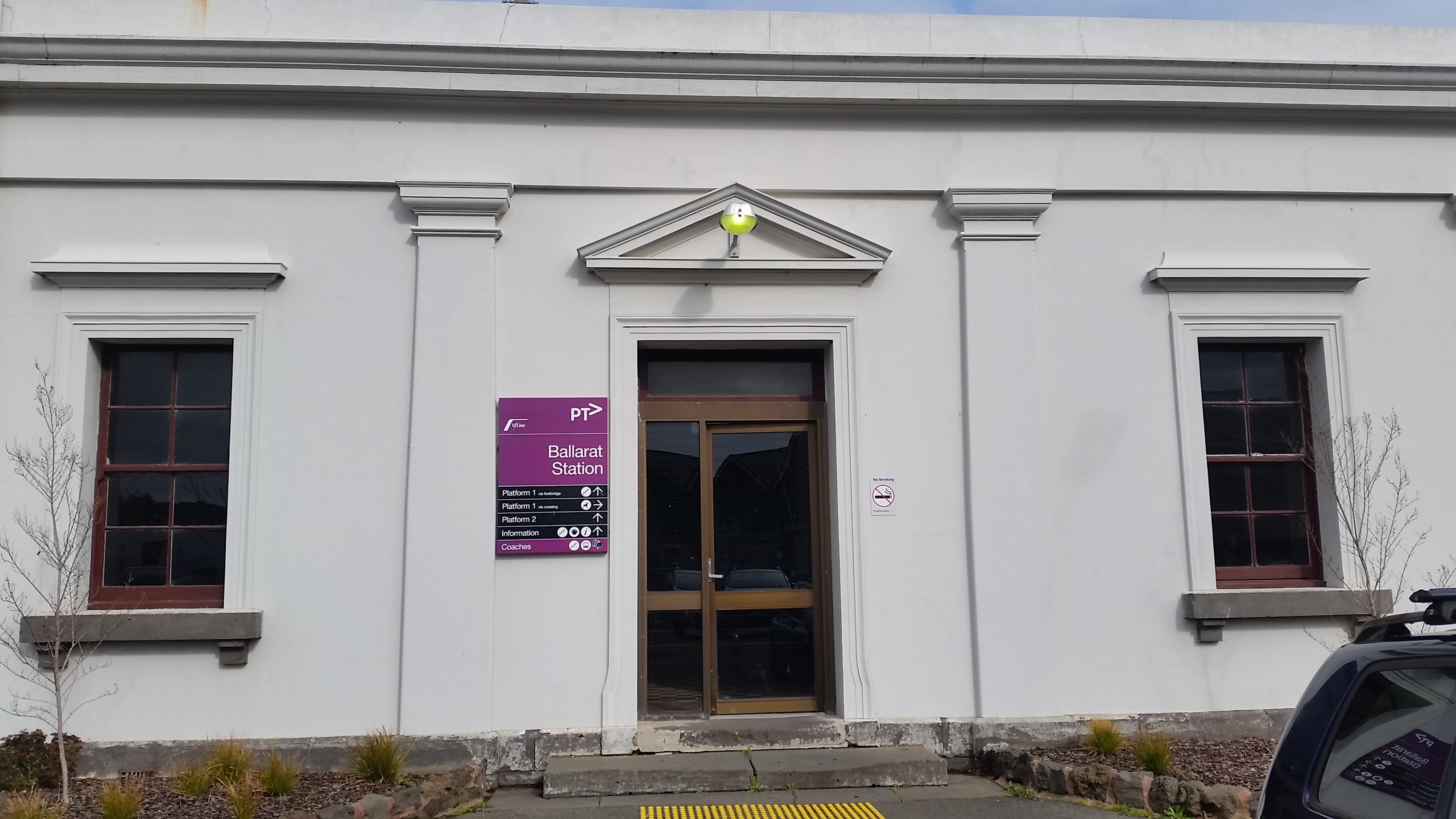 Modern and highly intrusive entry door to the north side station building